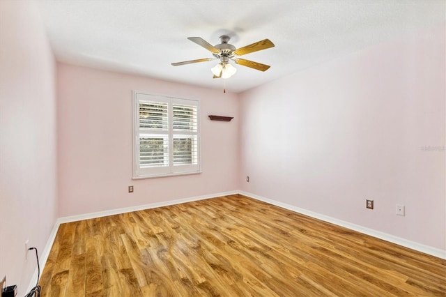 spare room with hardwood / wood-style flooring and ceiling fan