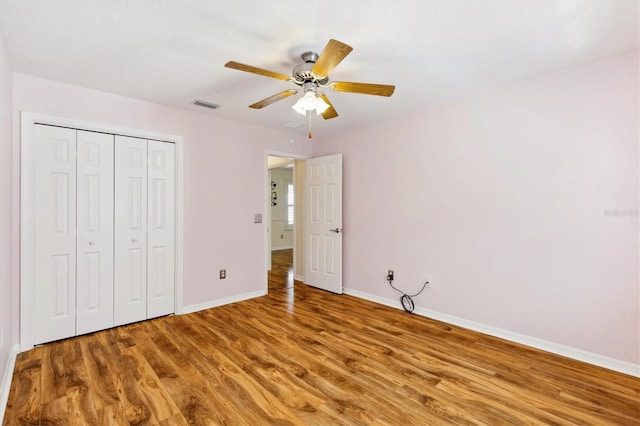 unfurnished bedroom with a closet, ceiling fan, and hardwood / wood-style flooring