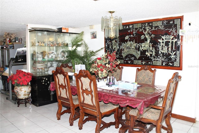 tiled dining space featuring a textured ceiling