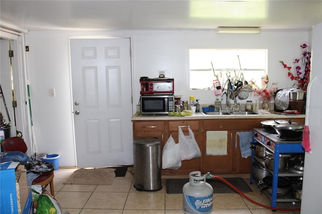 kitchen featuring sink and light tile patterned floors