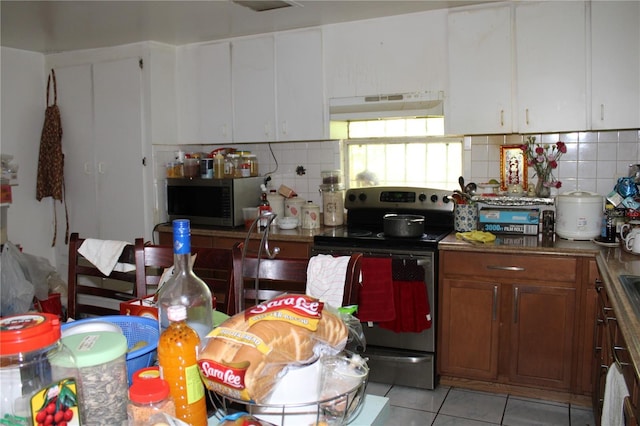 kitchen featuring backsplash, stainless steel appliances, and white cabinets