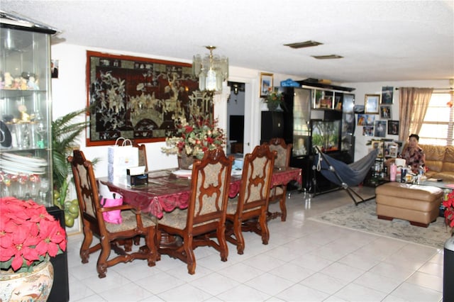 dining space featuring a notable chandelier and a textured ceiling