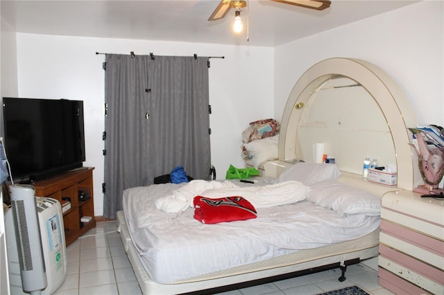 bedroom with light tile patterned floors and ceiling fan