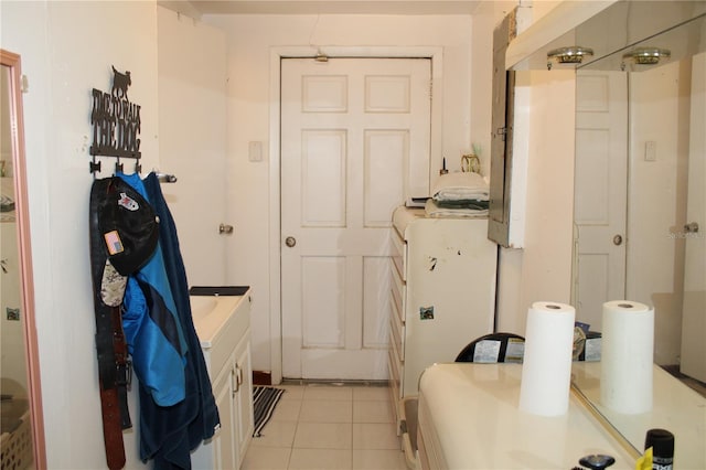 bathroom featuring vanity, a shower, and tile patterned floors