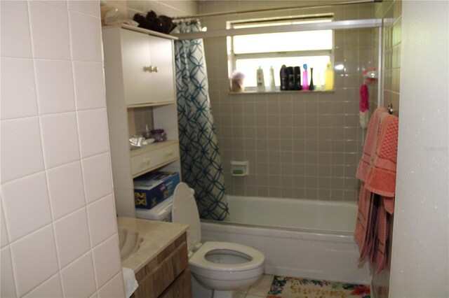 full bathroom featuring tile patterned floors, vanity, toilet, and shower / bath combo with shower curtain