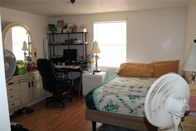 bedroom featuring a textured ceiling and light wood-type flooring