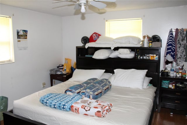 bedroom with ceiling fan and dark hardwood / wood-style floors