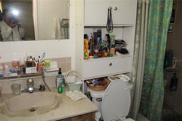 bathroom with curtained shower, tasteful backsplash, tile walls, vanity, and toilet