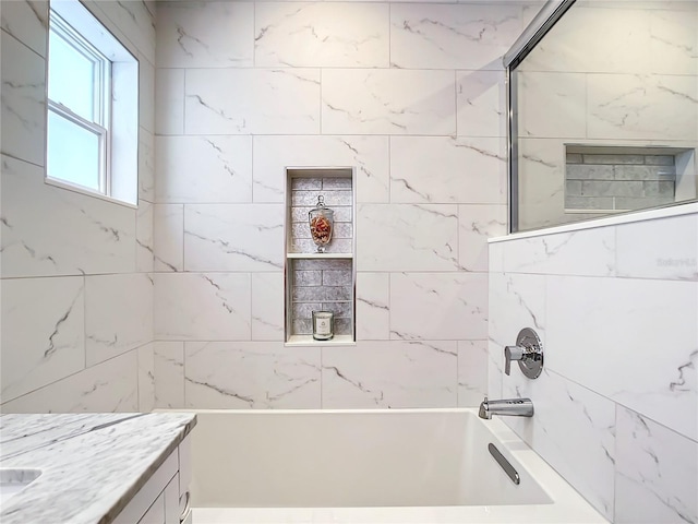 bathroom featuring vanity and tiled shower / bath combo