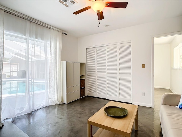 unfurnished living room with ceiling fan