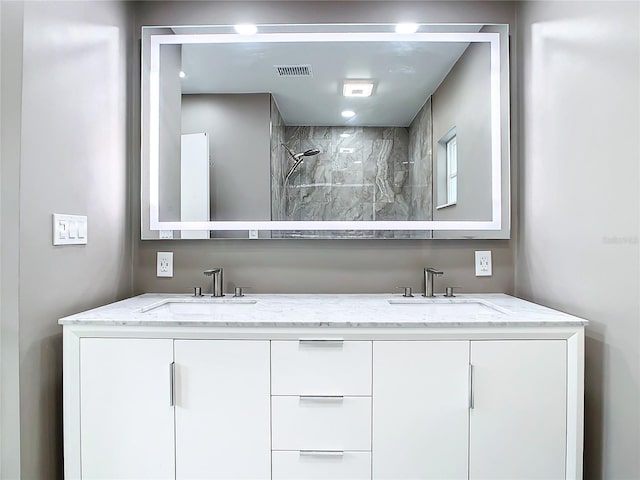 bathroom with vanity and a shower