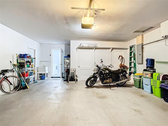 garage featuring electric panel and a garage door opener