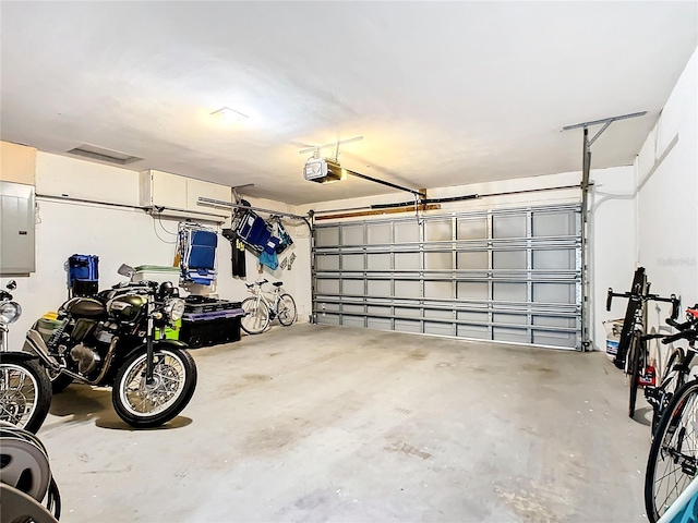 garage featuring electric panel and a garage door opener