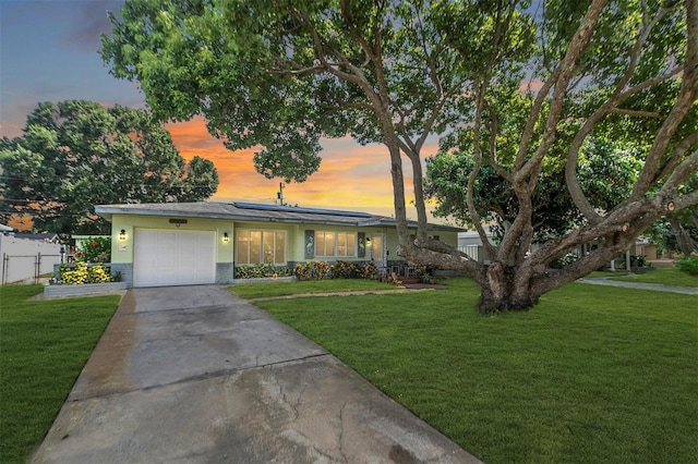 single story home with a yard and a garage