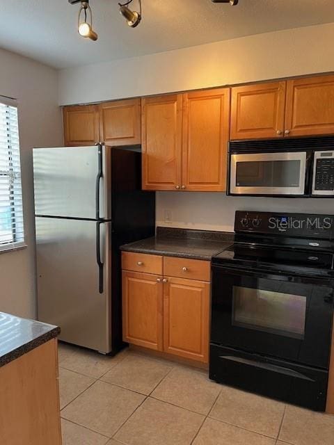 kitchen featuring light tile patterned floors and stainless steel appliances