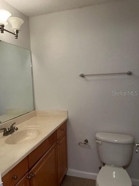 bathroom with toilet and vanity