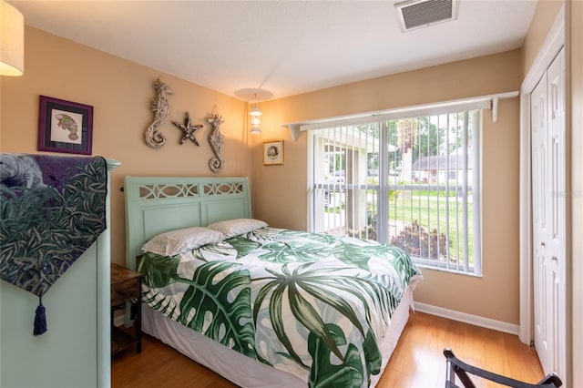 bedroom with light wood-type flooring and a closet