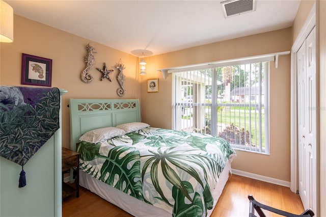 bedroom with a closet and light hardwood / wood-style floors