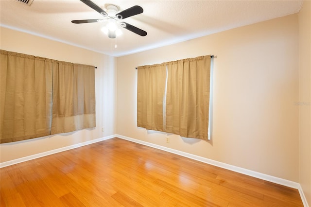 unfurnished room featuring hardwood / wood-style flooring, ceiling fan, and a textured ceiling