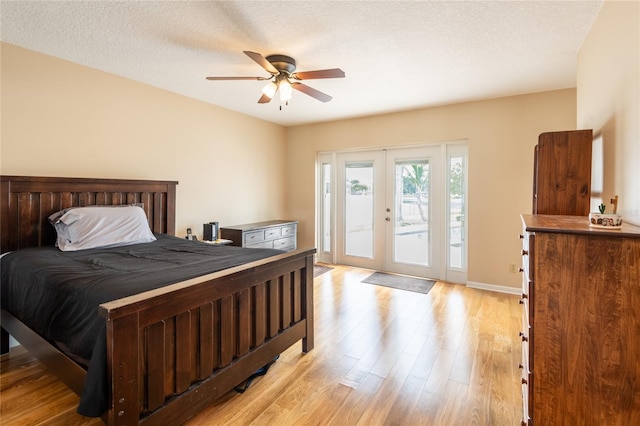 bedroom with access to outside, french doors, a textured ceiling, ceiling fan, and light hardwood / wood-style flooring