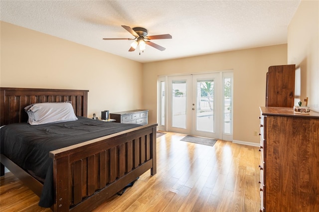 bedroom with light wood-type flooring, french doors, access to outside, ceiling fan, and a textured ceiling