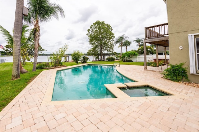 view of pool with a lawn, a patio, and an in ground hot tub