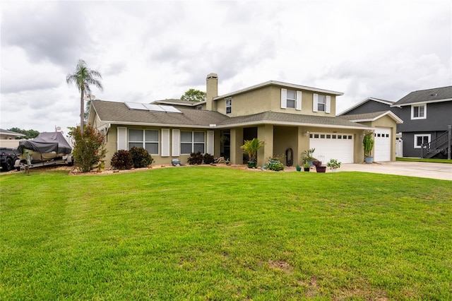 view of front of property featuring solar panels, a front yard, and a garage