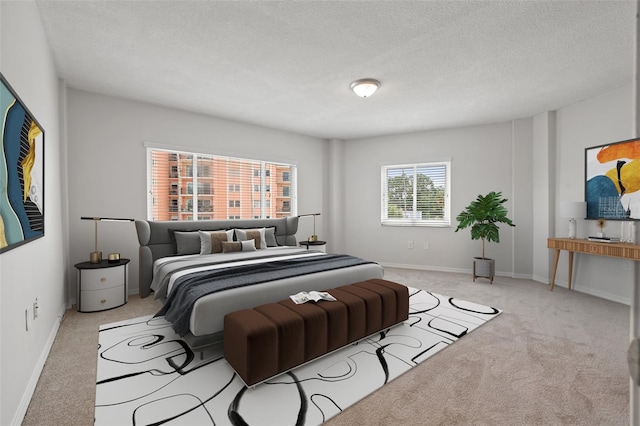 bedroom featuring a textured ceiling and light carpet