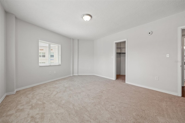 carpeted empty room with a textured ceiling