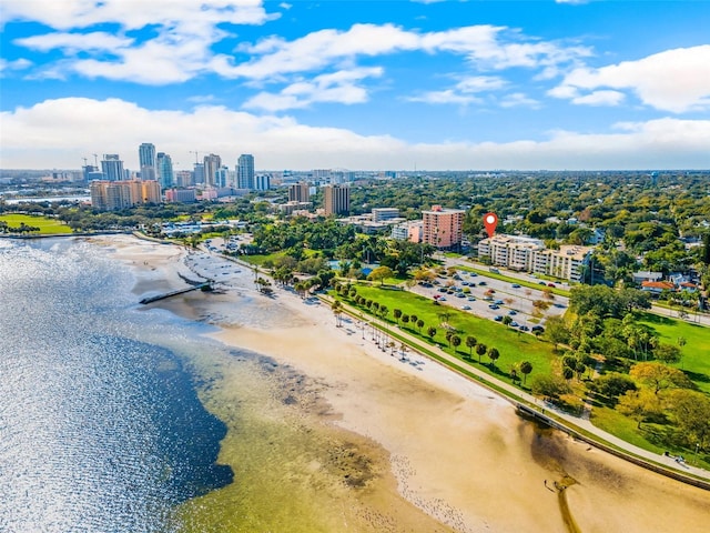 birds eye view of property featuring a water view and a beach view