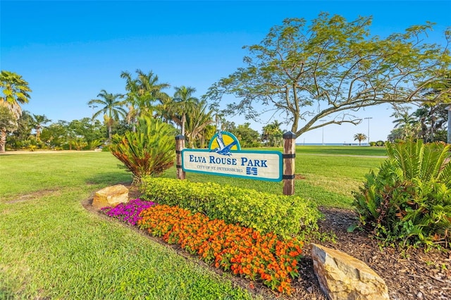 community sign featuring a lawn