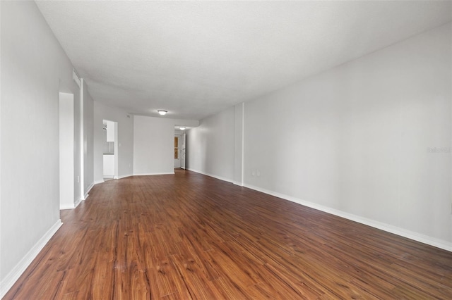 1200 N Shore Dr NE Unit 301, Saint Petersburg, FL 33701 - unfurnished living room with baseboards and dark wood finished floors
