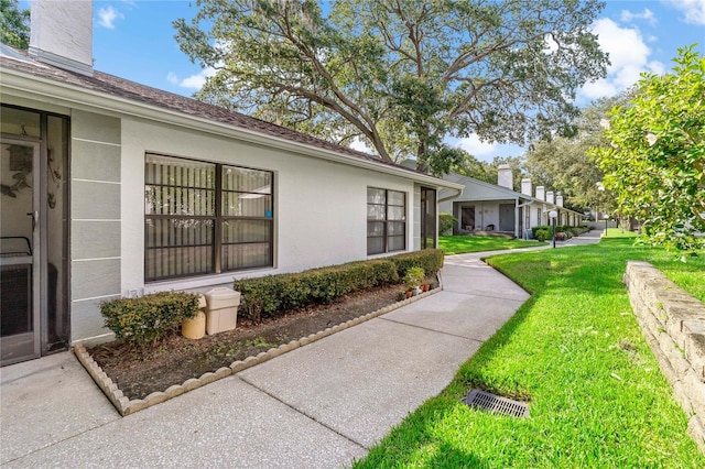 view of side of home with a yard