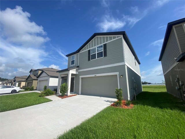 view of front of property featuring a garage and a front lawn