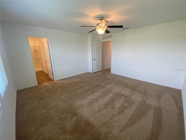 carpeted spare room featuring ceiling fan