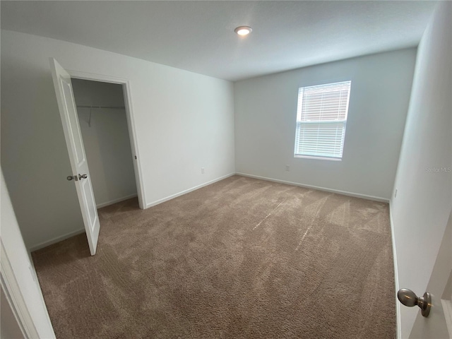 unfurnished bedroom with carpet floors and a closet