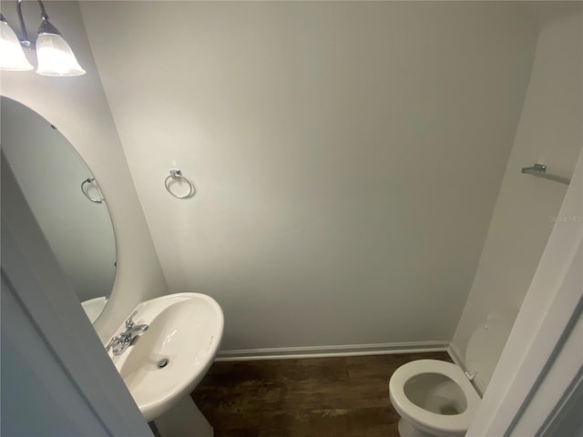 bathroom featuring sink, toilet, and hardwood / wood-style floors