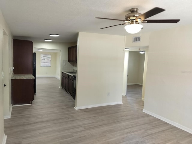 kitchen with tasteful backsplash, black appliances, dark brown cabinetry, light wood-type flooring, and ceiling fan