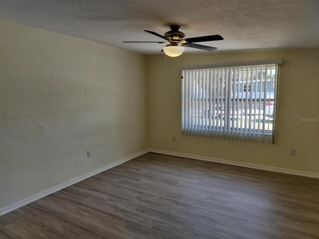 spare room with hardwood / wood-style flooring, a textured ceiling, and ceiling fan