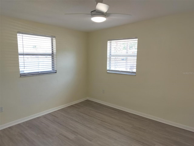 unfurnished room with ceiling fan and hardwood / wood-style flooring