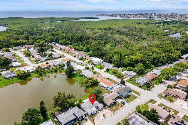 aerial view featuring a water view, a residential view, and a view of trees