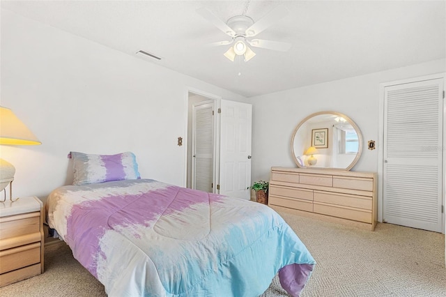 bedroom featuring carpet floors, visible vents, and a ceiling fan