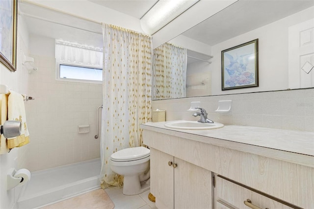 full bathroom featuring tasteful backsplash, toilet, tile patterned flooring, a tile shower, and vanity