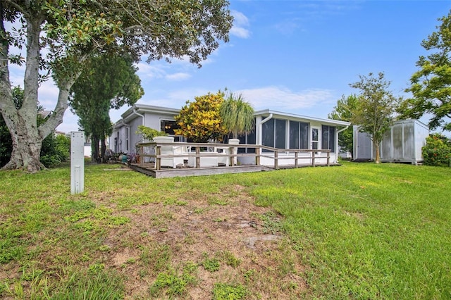 back of house with a sunroom and a yard