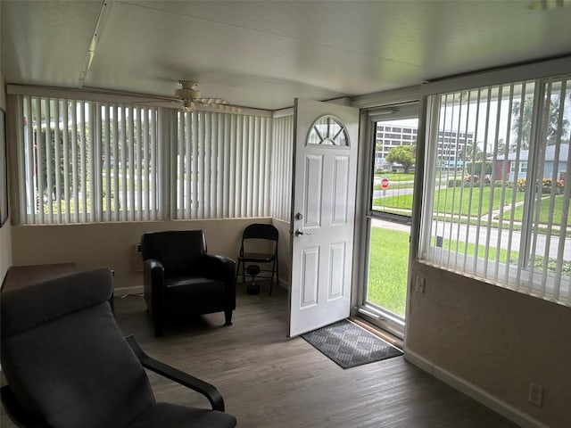 sunroom / solarium featuring ceiling fan