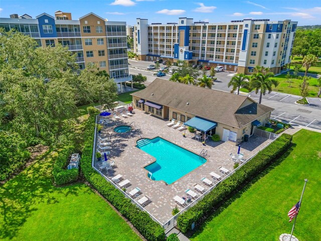 community pool with a patio and a yard