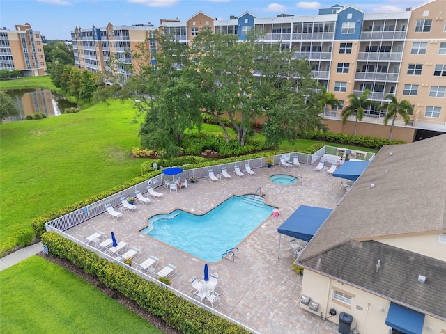 view of swimming pool featuring a water view, central AC unit, a patio area, and a lawn