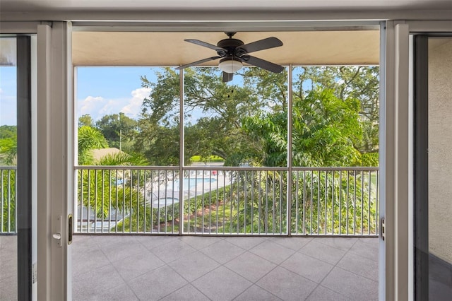 unfurnished sunroom featuring ceiling fan