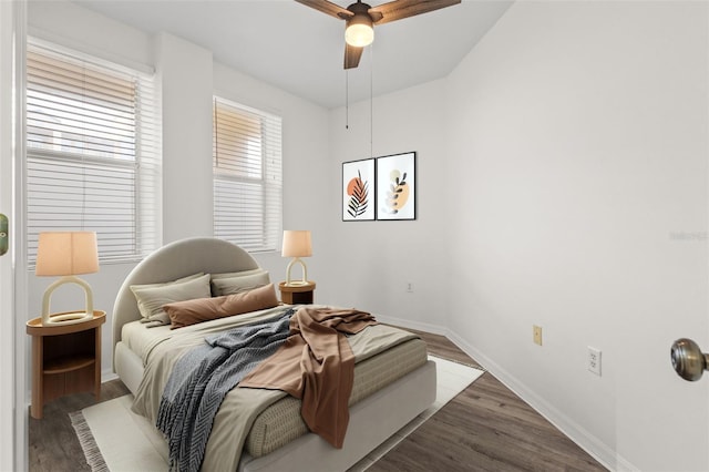 bedroom featuring ceiling fan, baseboards, and wood finished floors