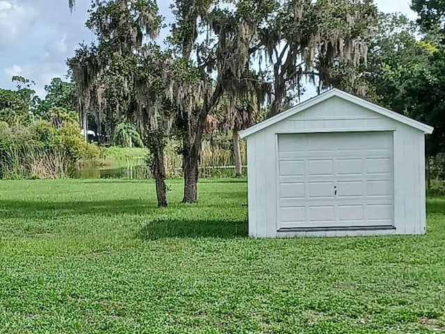 garage featuring a lawn